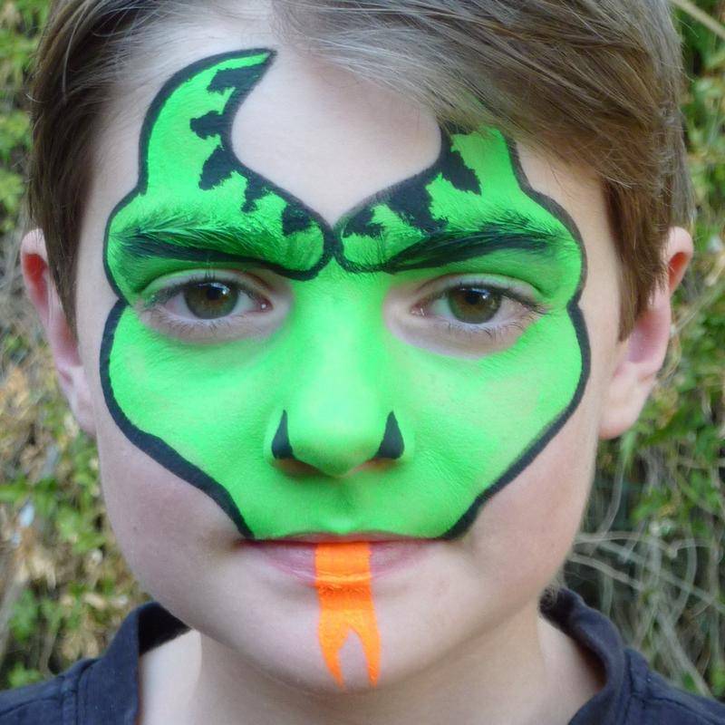 Dragon-face face painting using TAG Neon Green and TAG Neon Orange