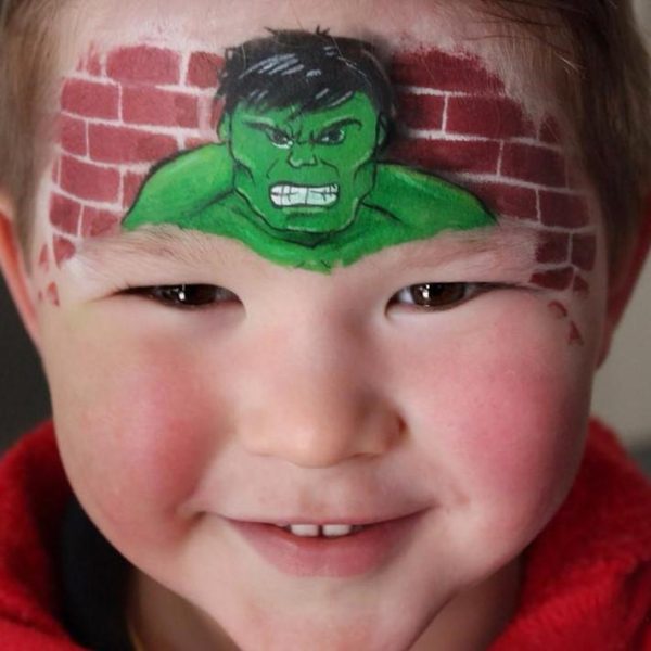 Hulk face painting with stencilled brick wall background