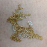 Leaping Reindeer glitter tattoo in TAG Holographic Gold and ABA Pearl White