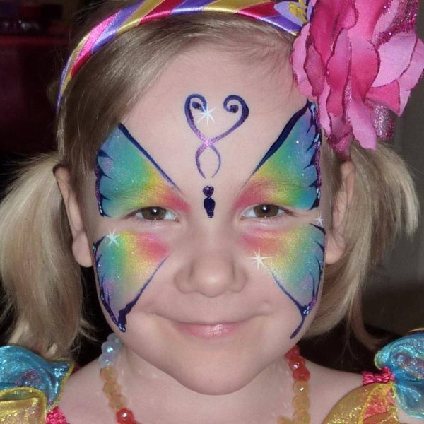 Rainbow Butterfly face painting using Face Paint World's PASTEL PEARL Split-cake and outlined in Fusion MAGIC DARK BLUE face paint