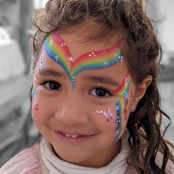 Rainbow face painting in RAINBOW LORIKEET one-stroke with PRETTY IN PINK Pixie Paint glitter gel