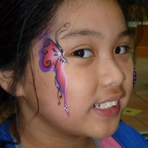 Small one-stroke butterfly face painting in TAG BERRY one-stroke face paint